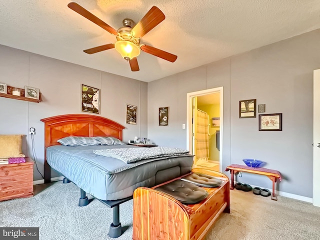 bedroom with ceiling fan, ensuite bathroom, a textured ceiling, and light carpet