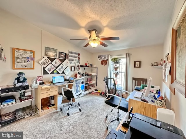 carpeted home office with a textured ceiling and ceiling fan