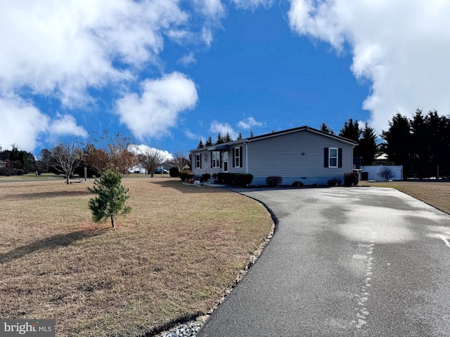 view of property exterior with a lawn