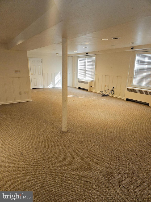 interior space with carpet and radiator