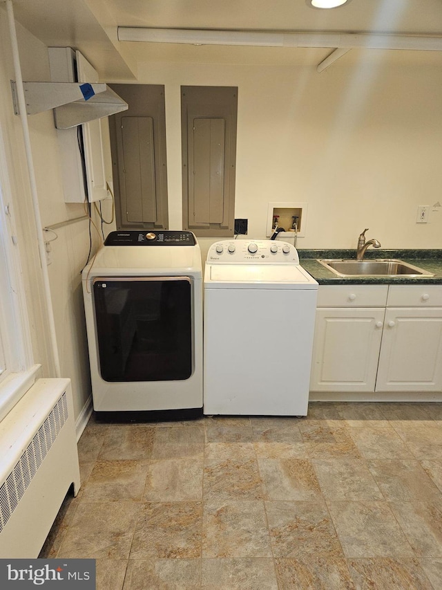 laundry room with cabinets, electric panel, radiator, sink, and washing machine and clothes dryer