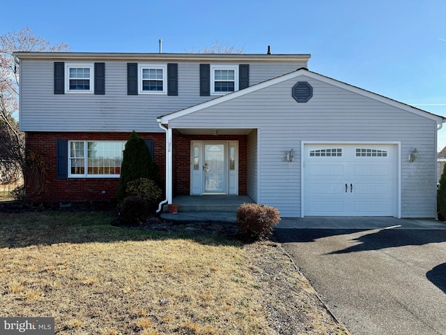 front of property with a front yard and a garage