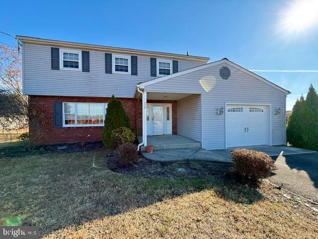 view of front property with a garage and a front yard