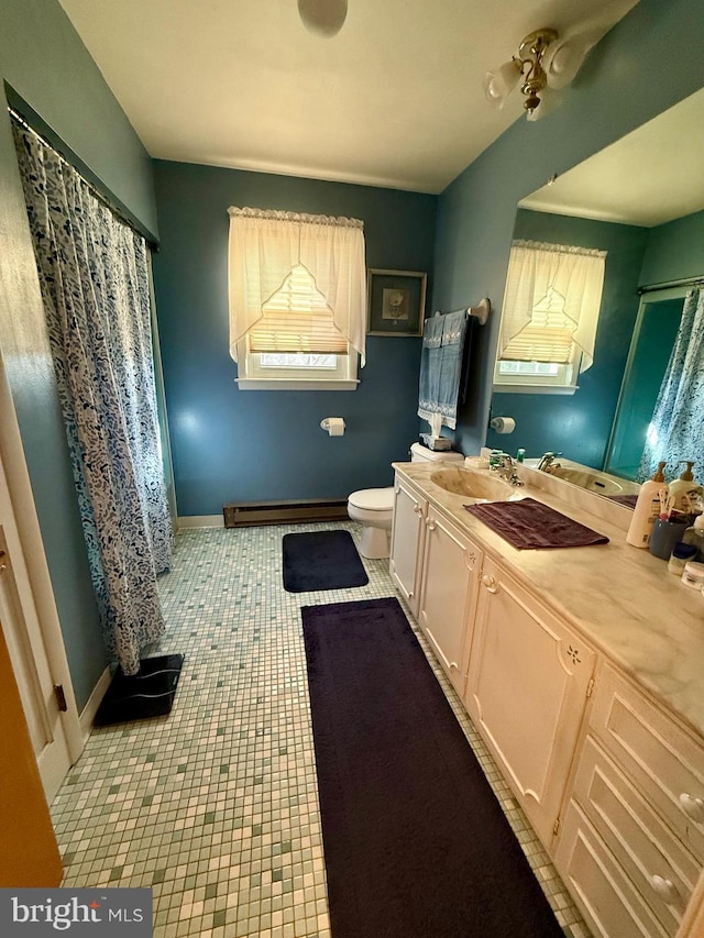 bathroom featuring ceiling fan, baseboard heating, tile patterned floors, toilet, and vanity