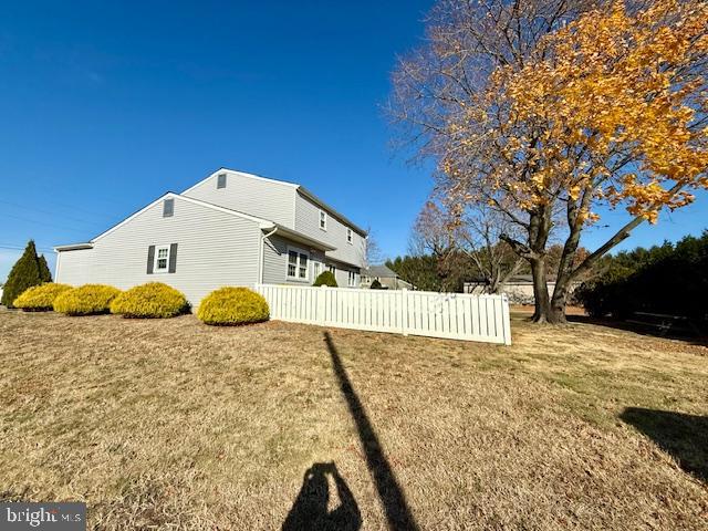 view of property exterior with a lawn