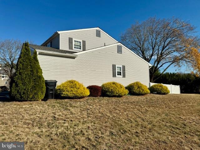 view of side of property featuring a yard