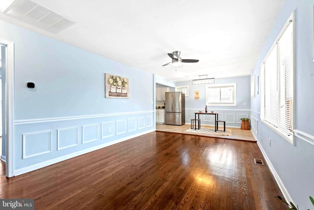 unfurnished living room featuring dark hardwood / wood-style floors and ceiling fan