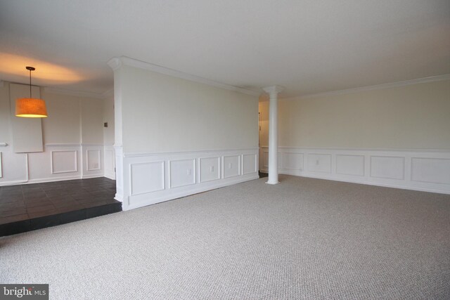 carpeted empty room featuring ornamental molding and decorative columns