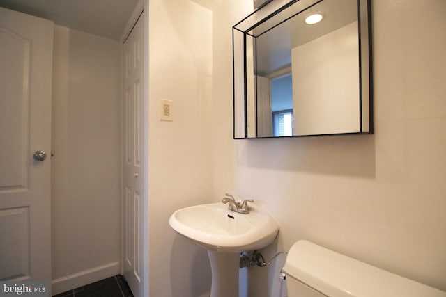 bathroom featuring tile patterned floors and toilet