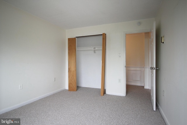 unfurnished bedroom with carpet flooring and a closet