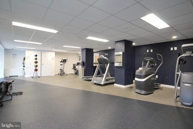 gym with a paneled ceiling