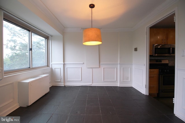 unfurnished dining area featuring ornamental molding and radiator