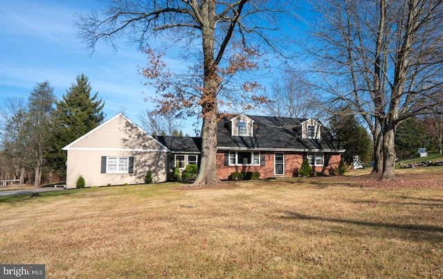 cape cod house with a front yard