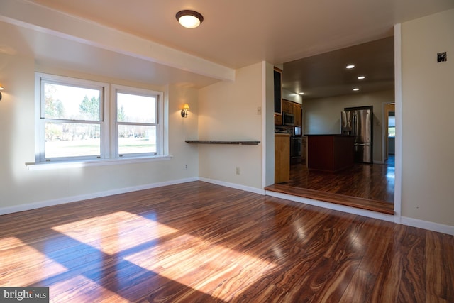 unfurnished living room with dark hardwood / wood-style flooring