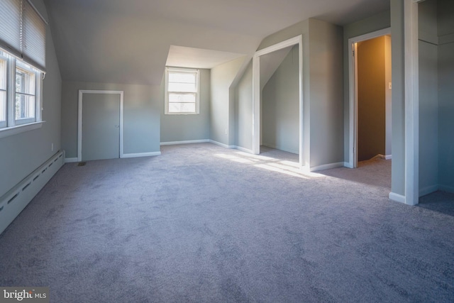 additional living space featuring carpet flooring, lofted ceiling, and a baseboard heating unit