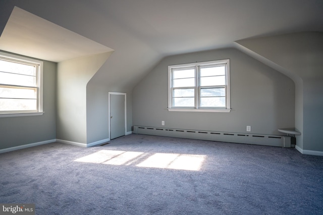 bonus room featuring carpet, baseboard heating, and vaulted ceiling