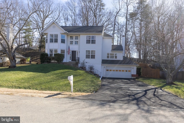 view of front of house featuring a garage and a front lawn