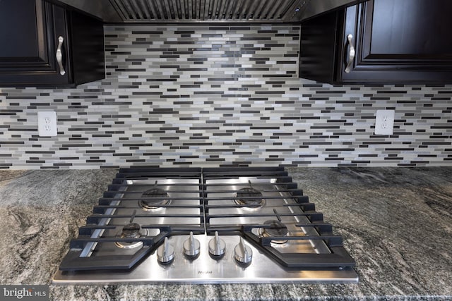 details featuring backsplash, gas cooktop, and exhaust hood