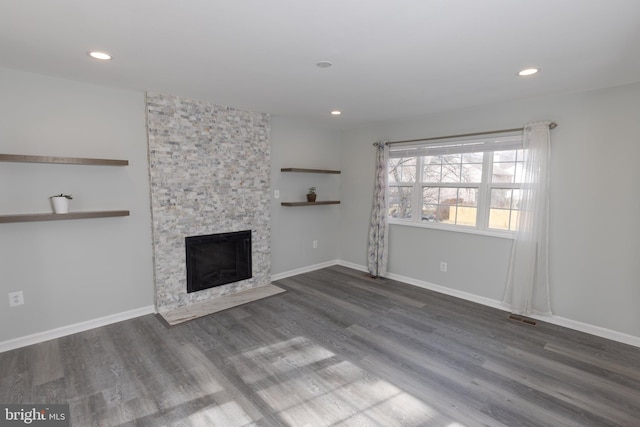 unfurnished living room featuring dark hardwood / wood-style floors and a fireplace