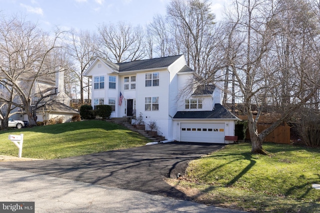 view of front of house featuring a garage and a front yard