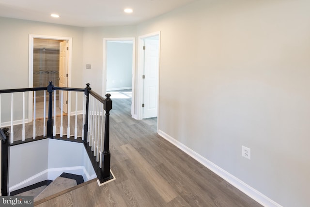 corridor with hardwood / wood-style floors