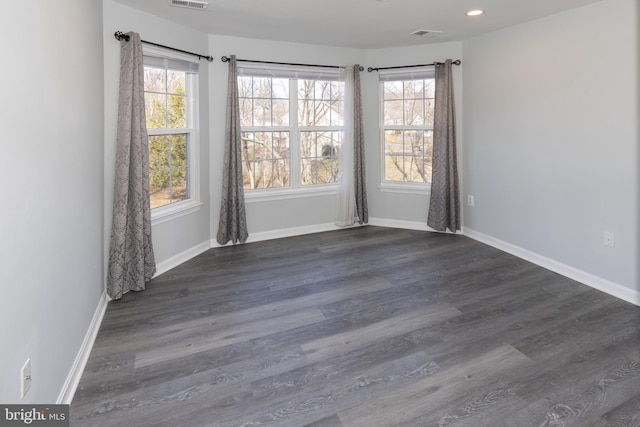 spare room featuring dark wood-type flooring