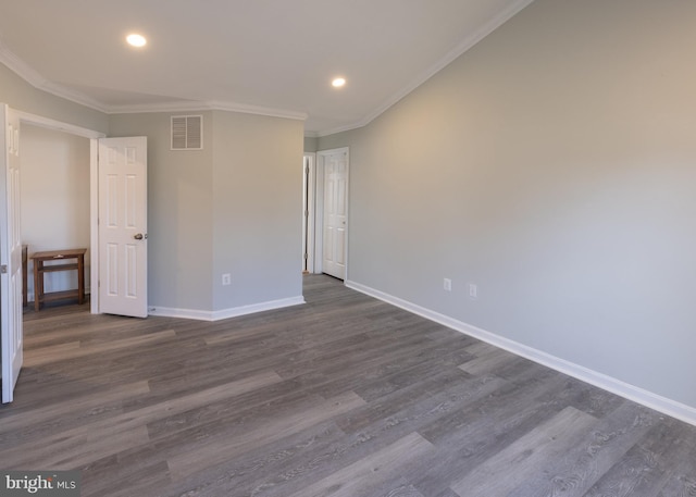 spare room with crown molding and dark hardwood / wood-style flooring