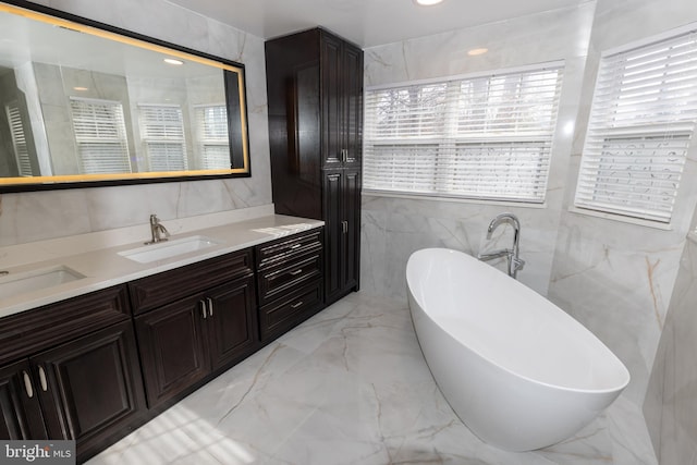 bathroom featuring vanity, tile walls, and a washtub