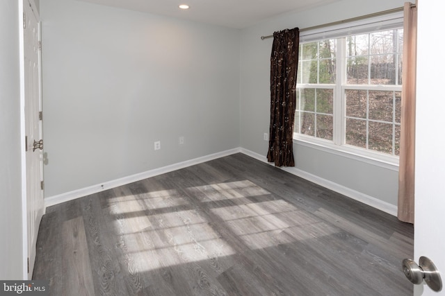 empty room with dark hardwood / wood-style floors