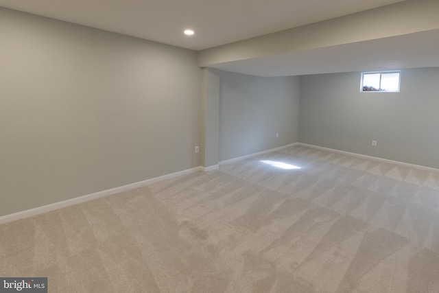 basement featuring light carpet