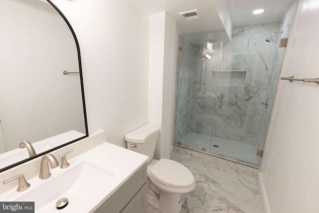 bathroom with vanity, toilet, and a shower with shower door