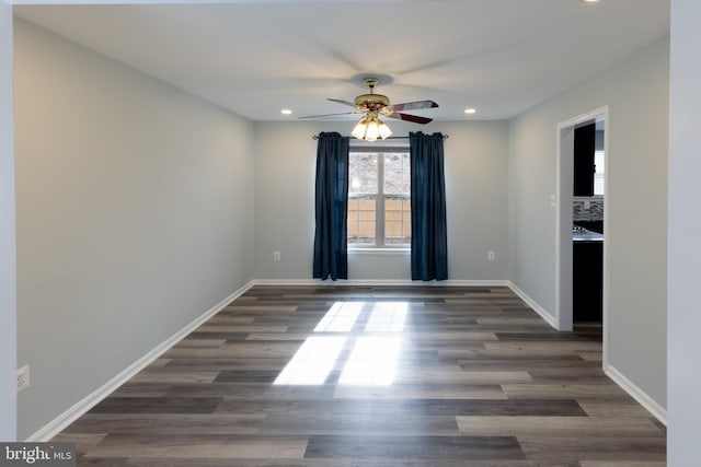 empty room featuring dark hardwood / wood-style flooring and ceiling fan