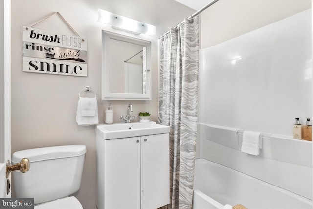 full bathroom featuring vanity, shower / tub combo, and toilet