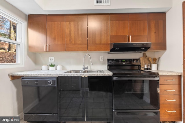 kitchen with black appliances, sink, and extractor fan