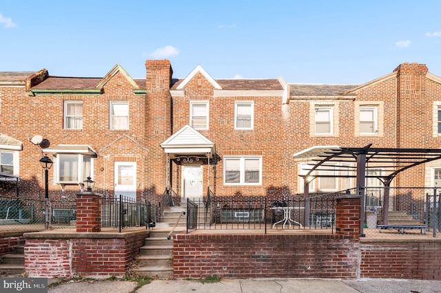 townhome / multi-family property featuring a pergola