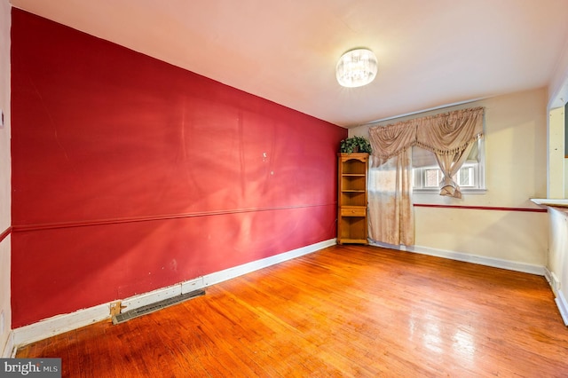 unfurnished room featuring hardwood / wood-style flooring