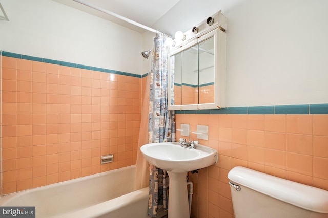 1313 Fanshawe St, Philadelphia, PA 19111 - full bathroom with toilet, shower / bath combo with shower curtain, a sink, tile walls, and a wainscoted wall