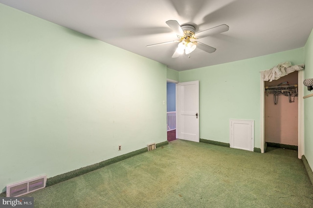 unfurnished bedroom with carpet, a closet, and ceiling fan