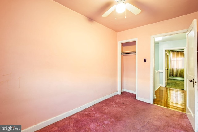 unfurnished bedroom with carpet, a closet, and ceiling fan