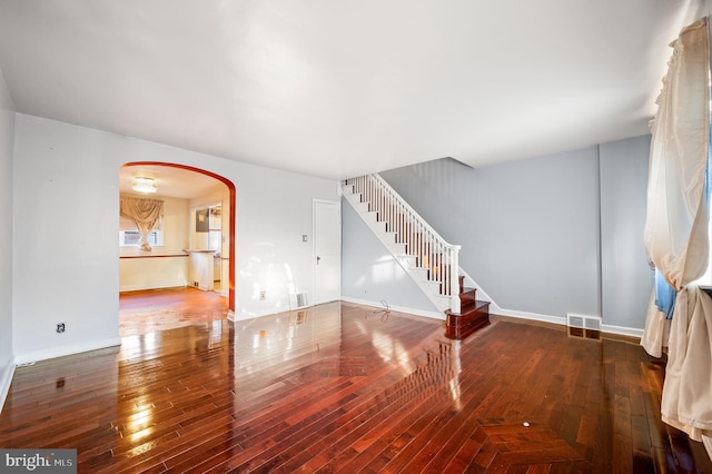 1313 Fanshawe St, Philadelphia, PA 19111 - unfurnished living room featuring arched walkways, stairs, wood-type flooring, and baseboards