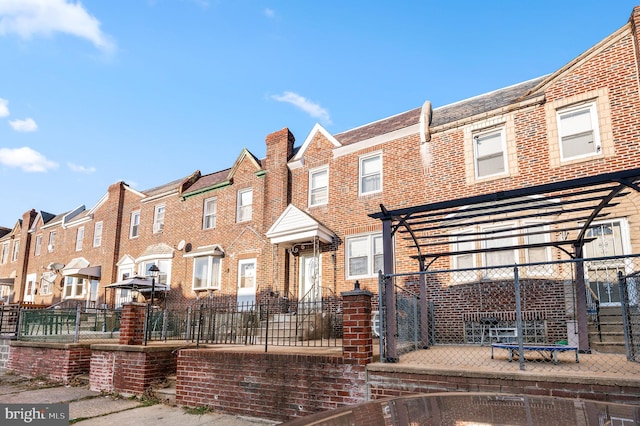 1313 Fanshawe St, Philadelphia, PA 19111 - townhome / multi-family property with brick siding, a pergola, and a residential view