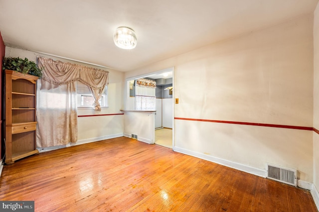 spare room with wood-type flooring