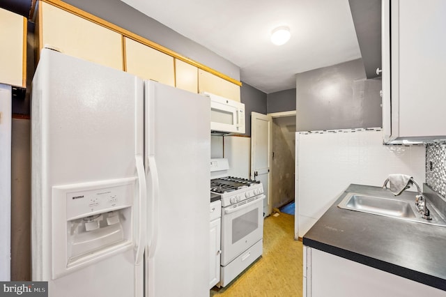 kitchen with decorative backsplash, white appliances, and sink