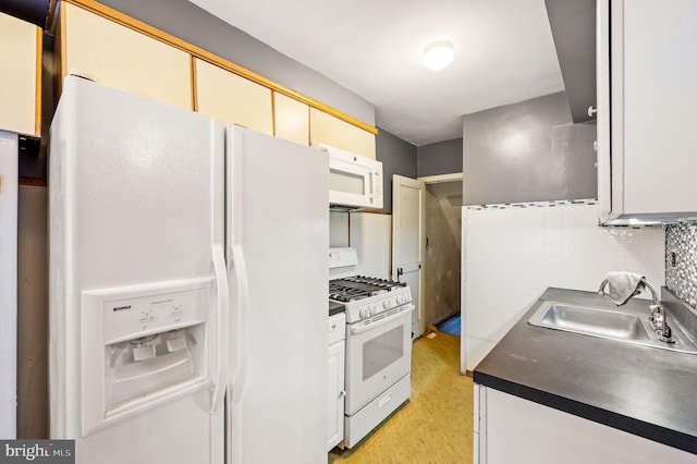1313 Fanshawe St, Philadelphia, PA 19111 - kitchen with white appliances, a sink, light wood-style flooring, dark countertops, and decorative backsplash