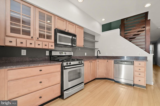 kitchen with light brown cabinets, light wood-type flooring, stainless steel appliances, and sink