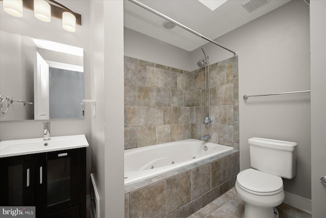 full bathroom featuring tile patterned floors, vanity, toilet, and tiled shower / bath