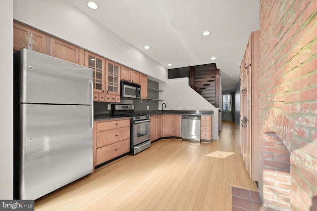 kitchen featuring sink, appliances with stainless steel finishes, and light hardwood / wood-style flooring