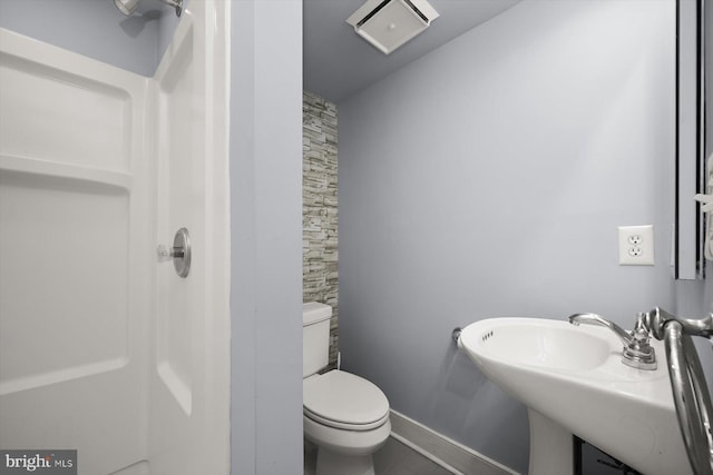 bathroom with tile patterned flooring, toilet, and sink