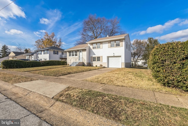 view of front of house with a front lawn and a garage