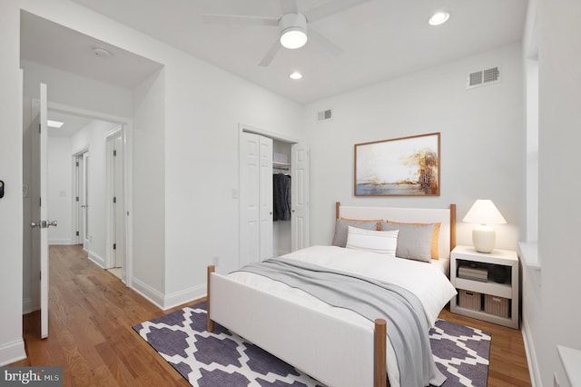 bedroom with light wood-type flooring, a closet, and ceiling fan